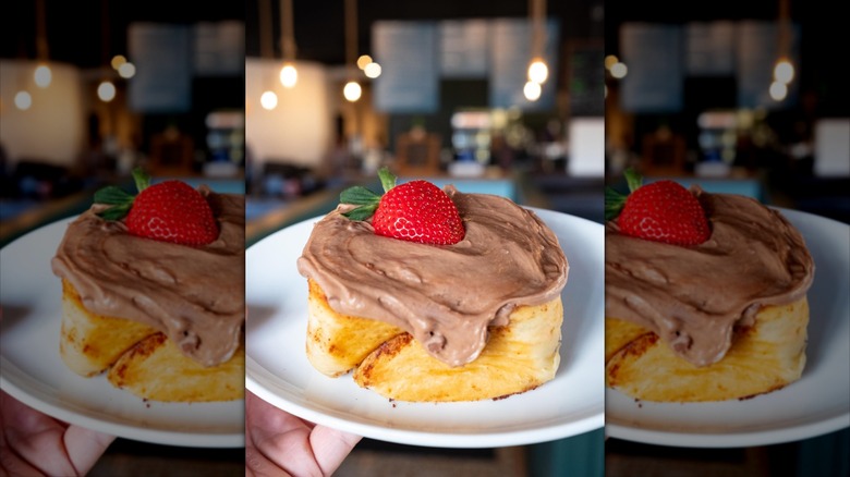 Good Lookin' Chocolate Strawberry Cinnamon Roll with fresh strawberry on top