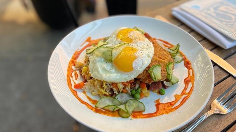 Soho Chicken + Whiskey crispy pork cutlet, andouille fried rice, pickled cukes, sunny eggs, maple-gochujang hot sauce