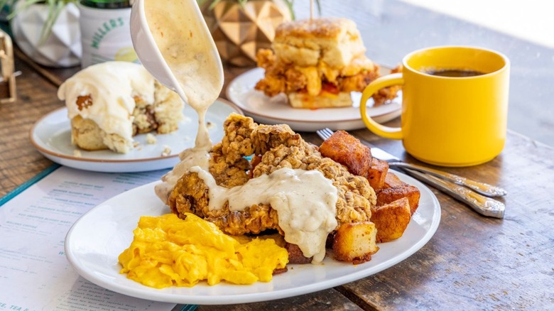 Millers All Day various brunch items, cinnamon roll, biscuit, gravy, fried chicken, eggs, coffee