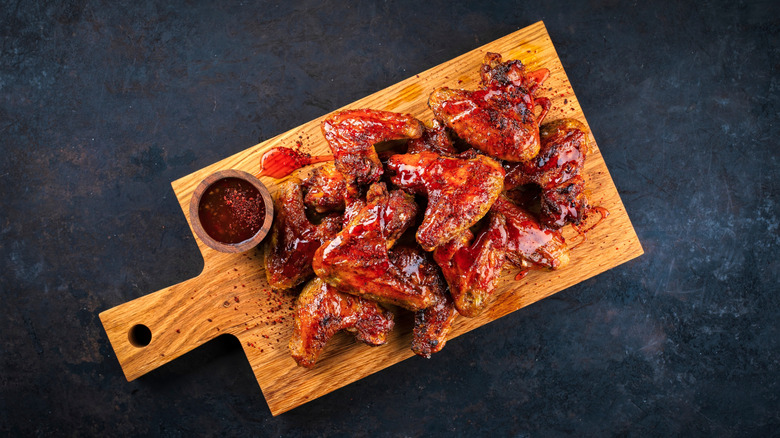 barbecue wings on wooden cutting board