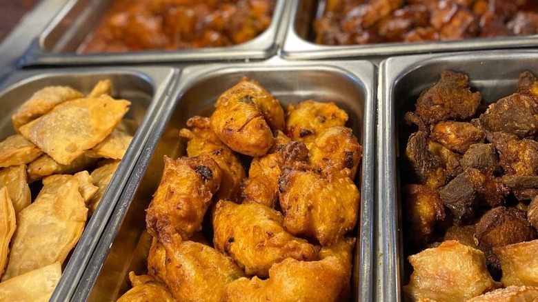 Various fried offerings from buffet line in trays at Mesa Buffet