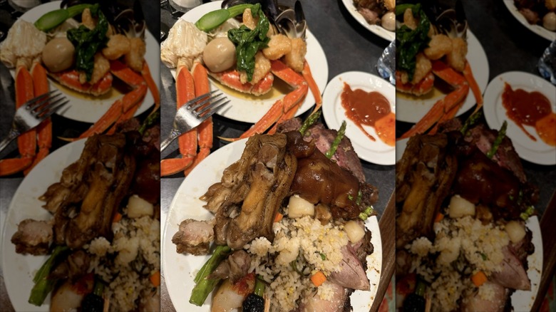 Plates of dinner items including crab legs at Falls Buffet
