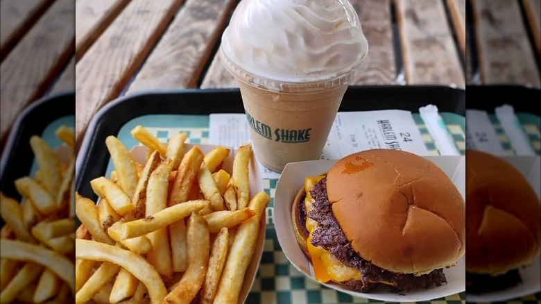 A tray with a burger, fries, and shake from Harlem Shake in NYC