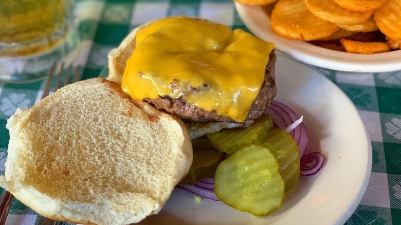 Open face cheeseburger and a plate of hand cut fries at J.G. Melon in NYC