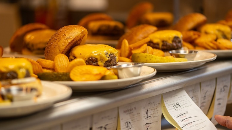 Many orders of the popular Dry-Aged Red Hook Tavern Burger ready to serve.