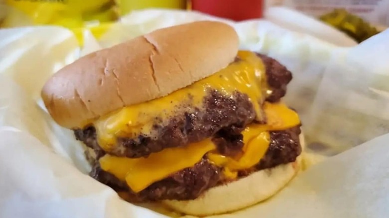 Bud's Double cheeseburger on paper in a basket
