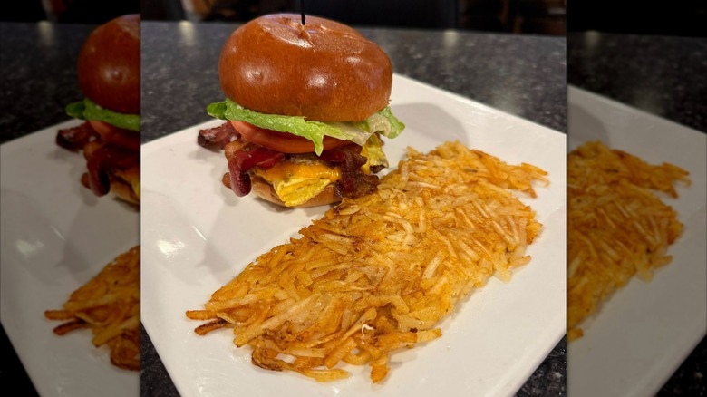 Heavy Hitter Burger on a plate next to hash browns