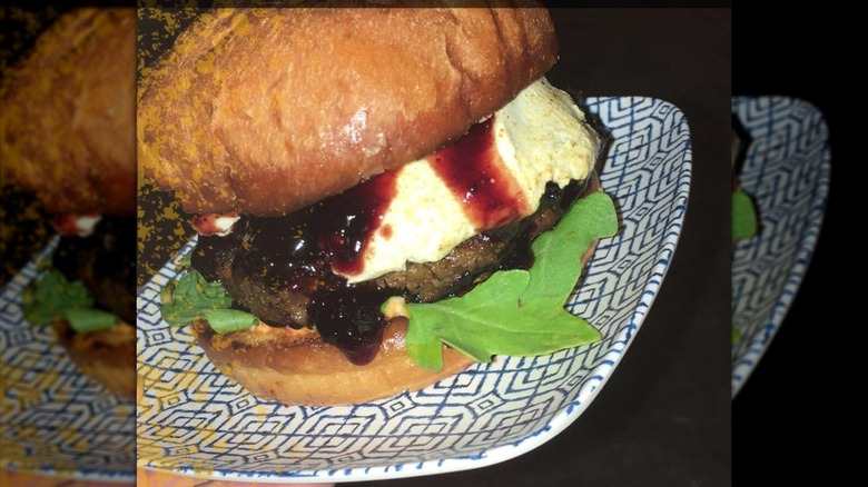 I'm Your Huckleberry Burger on a paper plate