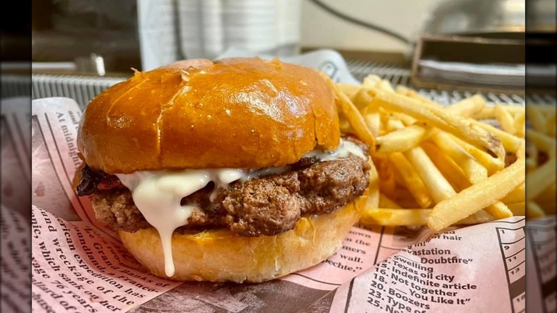 Montana Burger with a side of fries on newspaper