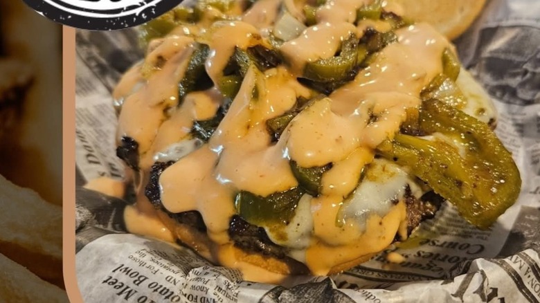 Angry Neighbor Burger on newspaper with the South Dakota Best Burger logo