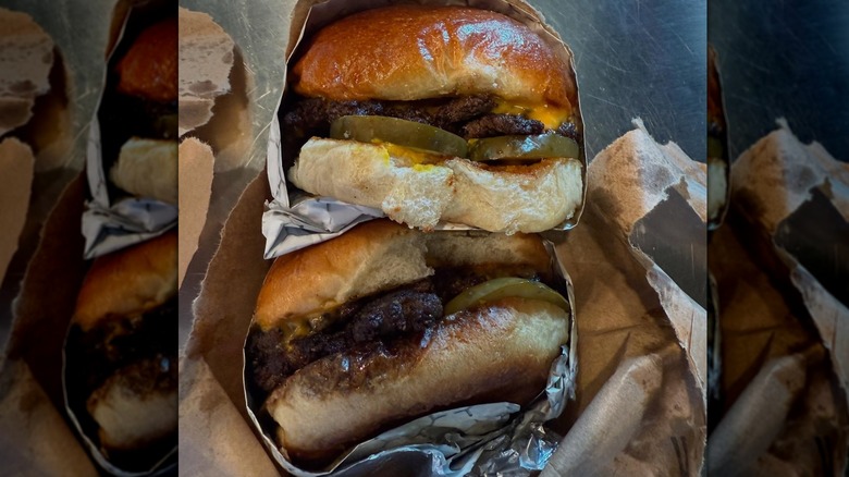 Two cheeseburgers wrapped in paper