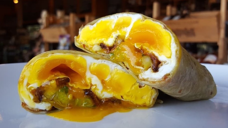 Egg yolk runs out of the bacon breakfast burrito at The Oak's Gourmet
