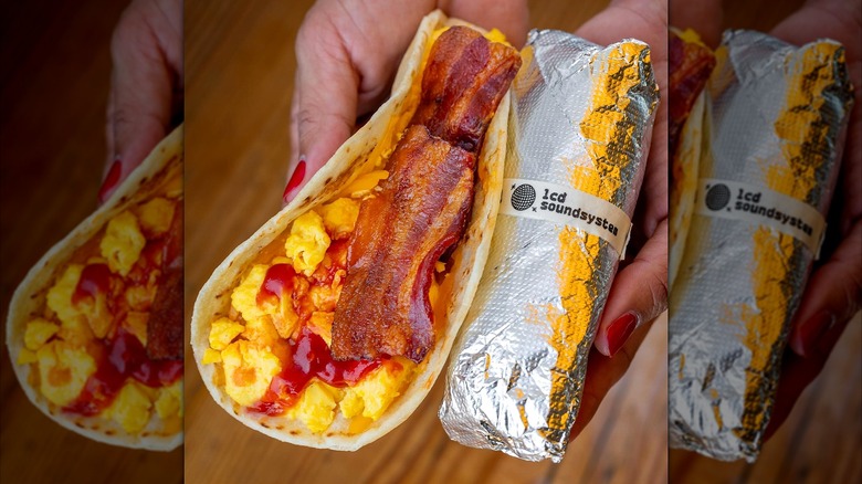 A woman holds two breakfast tacos from HomeState
