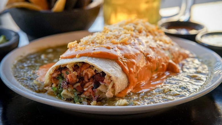 A wet burrito on a plate from Cacao Mexicatessen