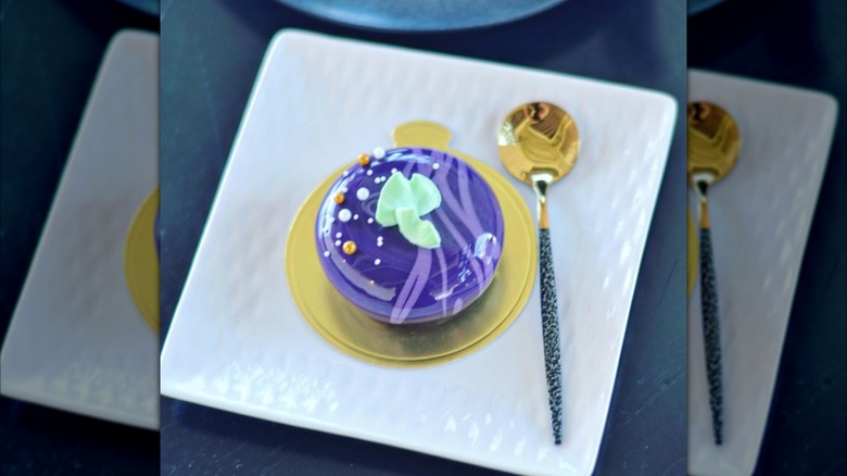 The Spoon ube cheesecake on white plate with gold spoon