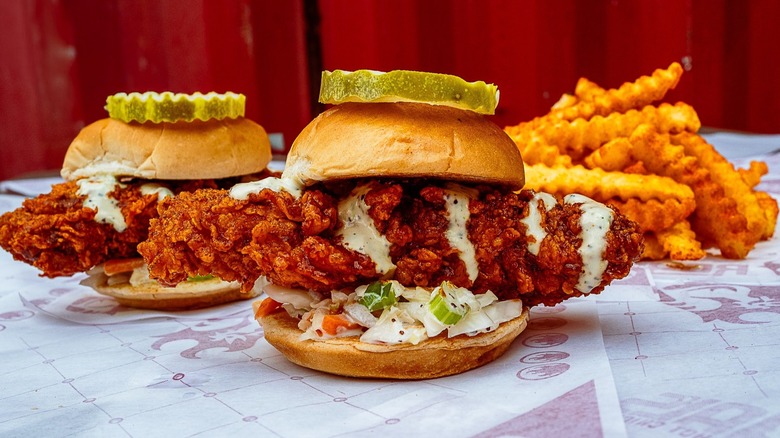 Royals Hot Chicken Hot Chicken Sliders and fries on branded wrapper