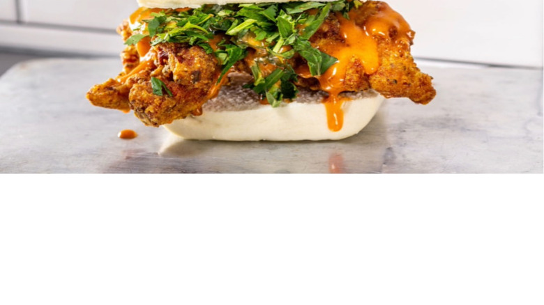 Ekiben chicken sandwich against subway tile backdrop