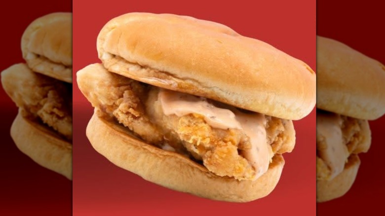 Connie's Chicken sandwich isolated on red background
