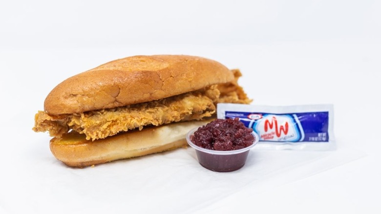 Farm Basket Gobbler sandwich with sides of cranberry sauce and miracle whip, isolated on white background