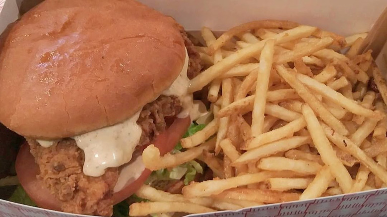 Stripes Burrito Co. Famous Buttermilk Fried Chicken Sandwich with fries in a cardboard tray