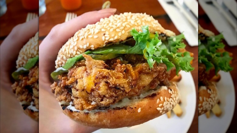 Allswell Crispy Chicken Sandwich, held over a plate