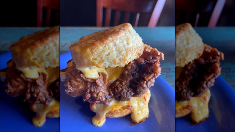 the Pimpin' Chicken Biscuit Sandwich on a blue plate at HomeGrown