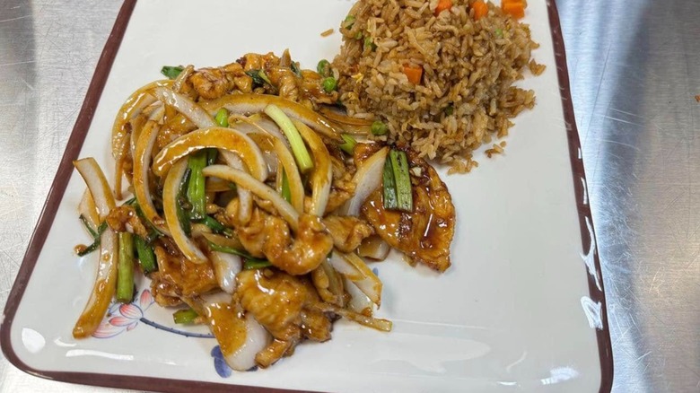 Chinese cuisine on square plate including fried rice from Chengdu Cuisine.
