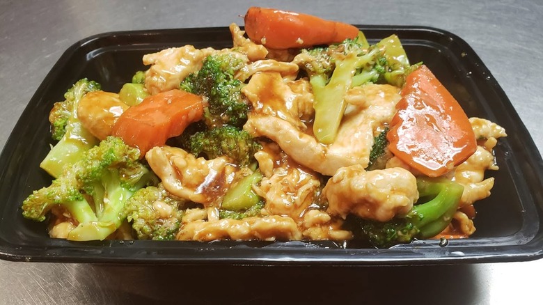 Chicken and broccoli from China Cafe in black to-go container.