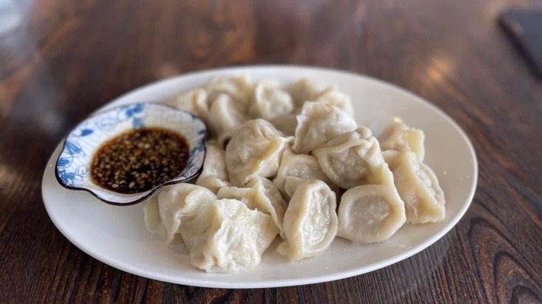Homemade Dumplings with side of dipping soy sauce from from Blue & Fly Asian Kitchen.