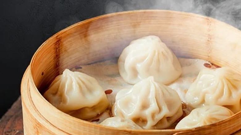 Pork soup dumplings in bamboo steamer basket from Szechuan Story.