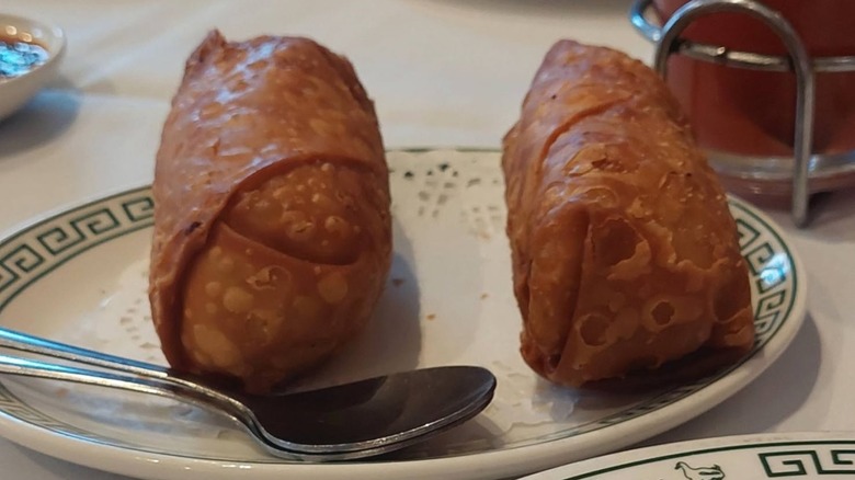 Two egg rolls on a plate at Peking Gourmet Inn