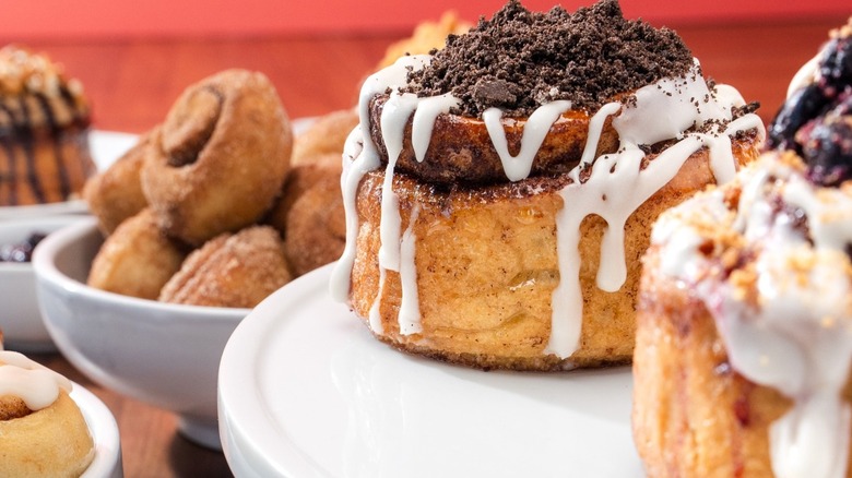 Kinnamons cinnamon rolls on cake stands close up