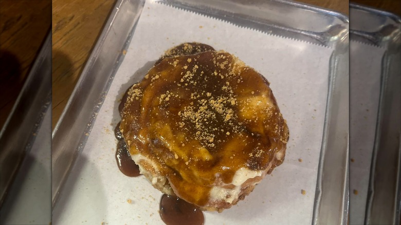 The Devine Cinnamon Roll Deli Cinnamon Roll fresh from the oven on a baking sheet