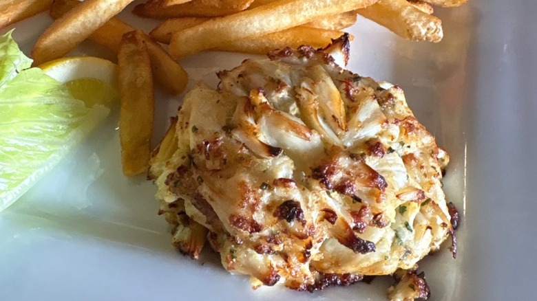 Crab cake with side of French fries at Woody's Dewey Beach