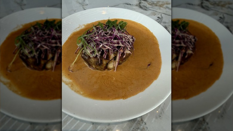 Crab cake at Prime & Providence on a plate with sauce