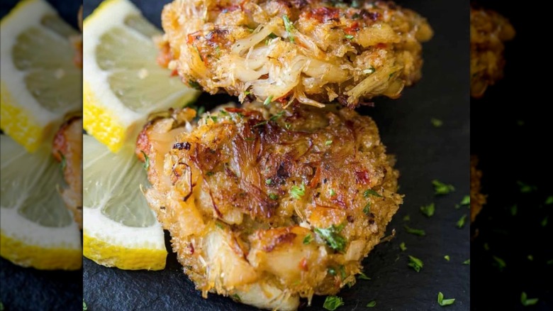 Fresh House-made Crab Cakes with lemon slice garnish at The Upper Cut KC