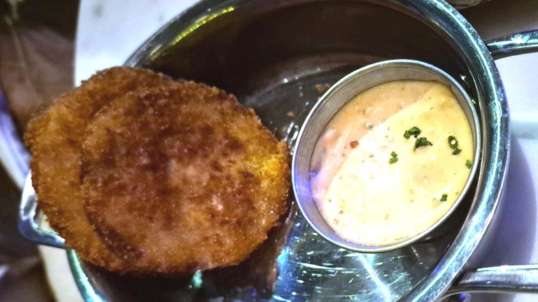 Crab cakes with dish of sauce at Hank's Seafood Restaurant