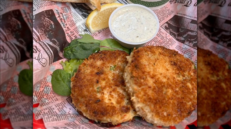 Crab cakes with remoulade sauce served on newspaper at Tony's Crab Shack