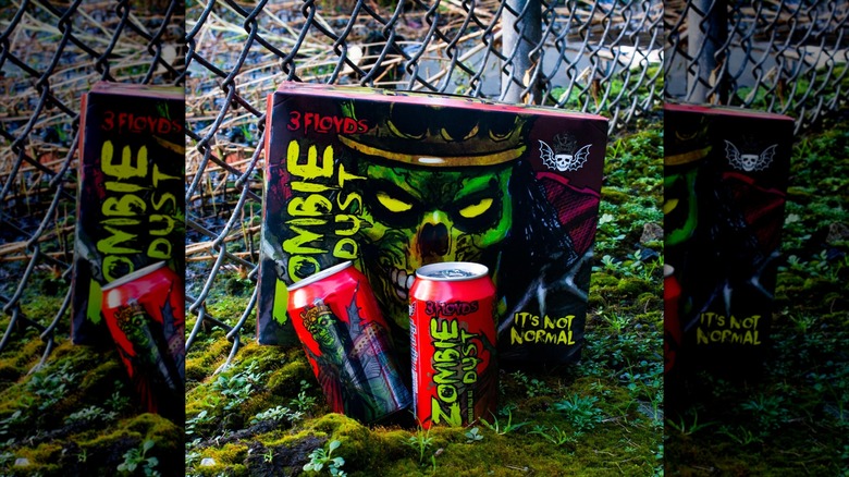 Beer cans in front of branded beer container
