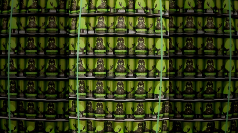 Wall of green colored beer cans