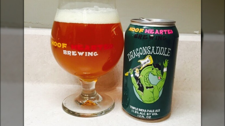 Can of Dragonsaddle IPA next to full beer glass