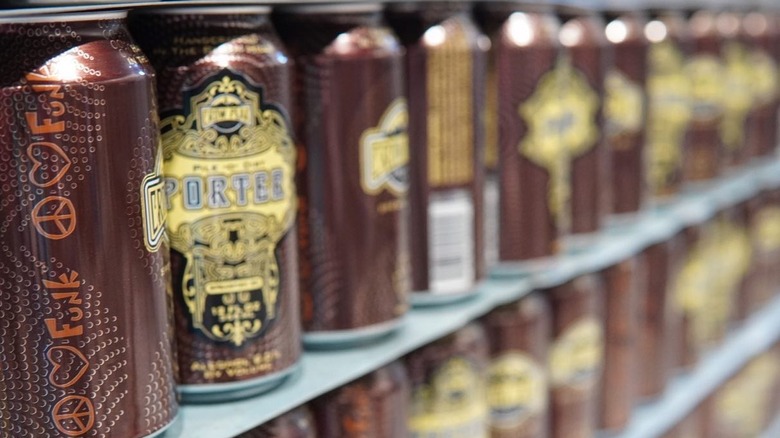 Rows of Pile O Dirty porter beer cans on store shelves
