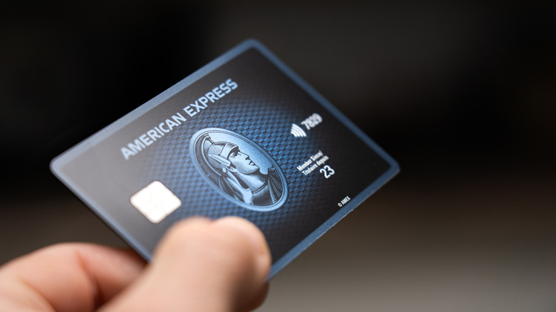 American Express card with dark blue color in front of black background