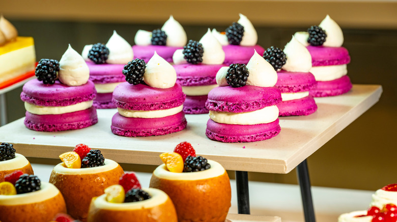 Assortment of desserts, including macaron, arranged on a stand