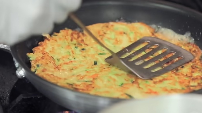 Kimchee pancake being prepared on stove in pan at Dae Gee Korean BBQ