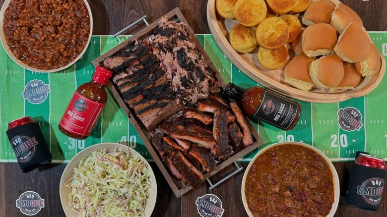 Game Day spread with brisket and beans and slaw and roles and chili from Smoque BBQ