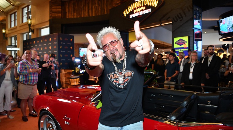 Guy Fieri poses with the iconic 1968 Chevrolet Camaro convertible from the hit TV series "Diners, Drive-Ins and Dives"