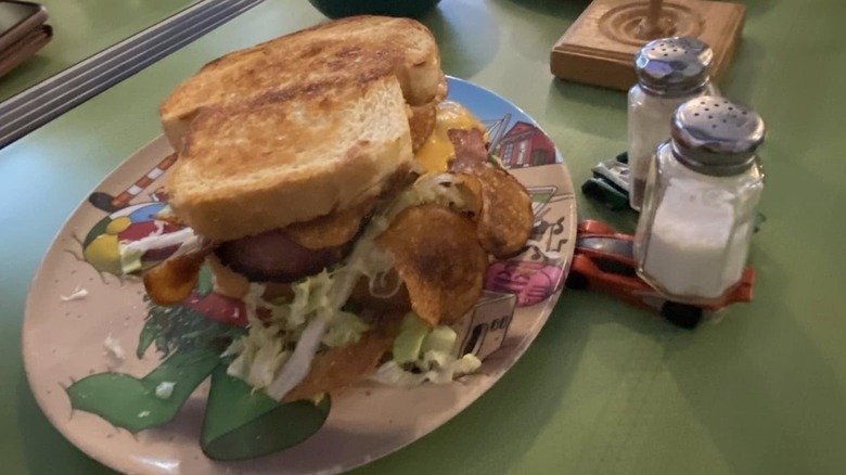 Fried bologna sandwich beside salt and pepper shakers on a table from Turkey and the Wolf