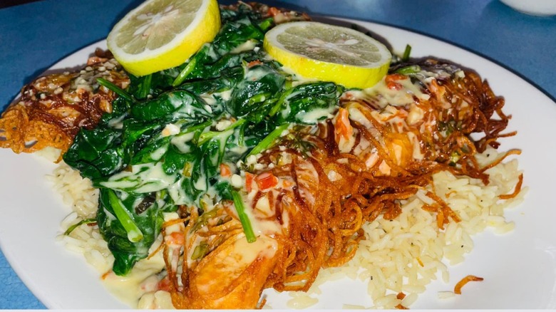 Potato Crusted Salmon topped with sliced lemon from Broadway Diner
