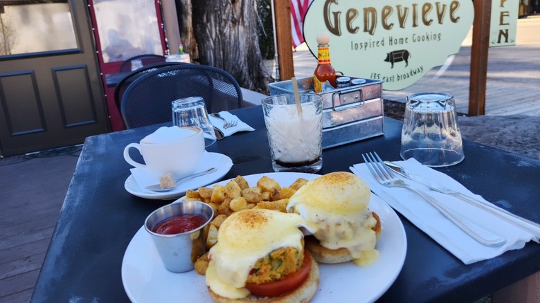 Crabcake Benedicts outside on patio dining table at Cafe Genevieve